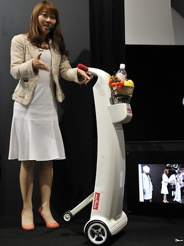 <p>A model displays Japanese electronics parts maker Murata's electric walking assistance "cane" for the elderly.</p> <p>Picture: AFP</p>