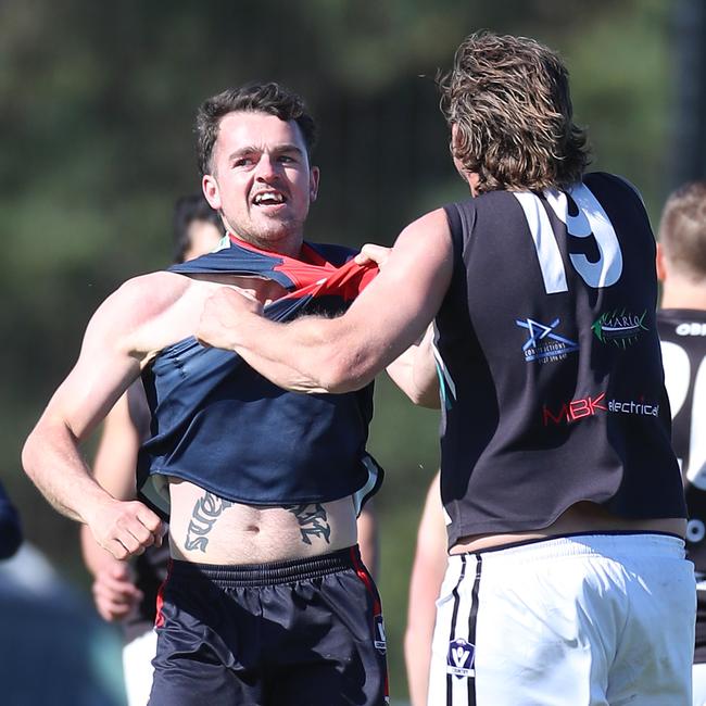 Swifts Creek’s Beau Hack tangles with Omeo-Benambra’s James Gibbs.