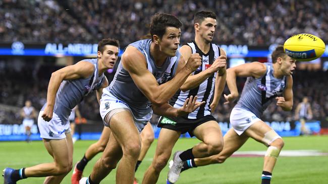 Port Adelaide’s Ryan Burton of the Power handballs against Collingwood at Marvel Stadium. Picture by Quinn Rooney/Getty Images.