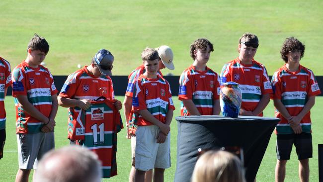 Nambour Crushers teammates holding Benjamin Hunter's uniform.