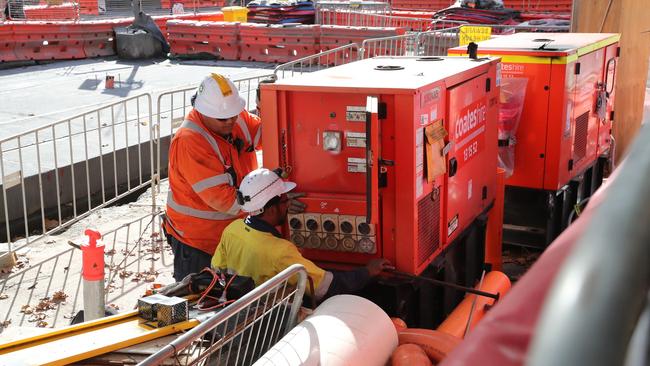 Workers inspect equipment on the light rail project near the intersection of George St and Ultimo Rd, where Ms Lambden received an electric shock in June. Picture: David Swift