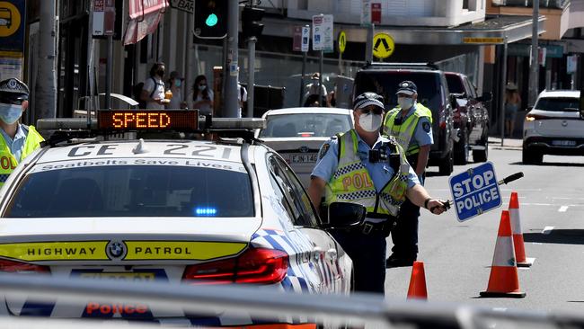 Bondi Beach sees police set up a roadside checkpoint to check drivers IDs ensuring they are within the 5km radius currently in place for exercise. Picture: Matrix