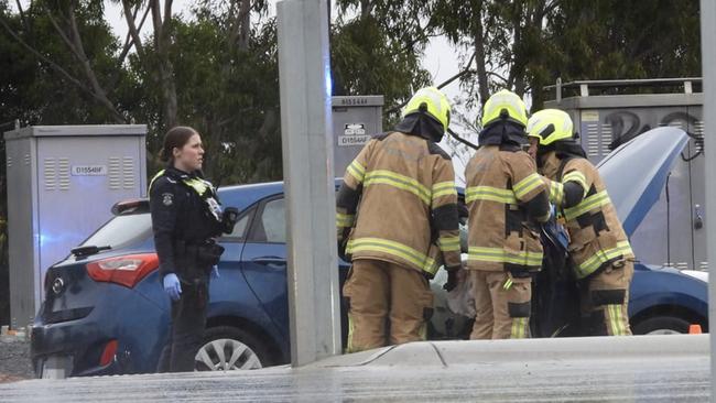 Images show crews working on a car at the scene.