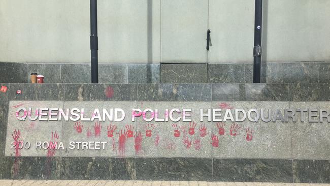 Protesters with red paint on their hands marked the Queensland Police Headquarters sign with handprints, signifying the QPS “has blood on their hands.”