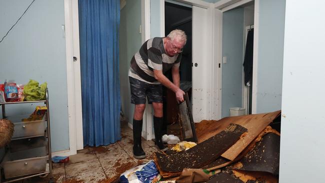 Cardwell resident Ian Rowe has lived in his Roma Street house for 36 years, and has never seen flood waters rise so high as they did on Sunday night. He returned to his home to try and salvage kitchen goods from his chipboard cupboard, which had crumbled onto the floor with everything inside. Picture: Brendan Radke