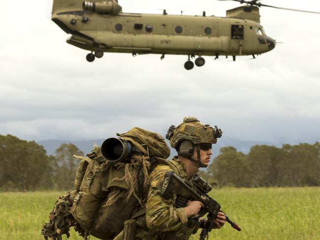 An Australian Army soldier from 3rd Battalion, The Royal Australian Regiment begins a patrol as a CH-47 Chinook departs during Exercise Brolga Run 23 in Ingham, Queensland. *** Local Caption *** The Australian Armys 3rd Brigade deployed to the Townsville Field Training Area to conduct their second major training exercise for 2023, Exercise Brolga Run, from 27th of April  19th of May. Over 1500 Townsville-based troops were put to the test on how to conduct stability, security, and evacuation operations against a simulated enemy.Exercise Brolga Run is the second of several training activities for 2023, as the 3rd Brigade prepares for Exercise Talisman Sabre with the US military and other partner forces later in the year. PHOTO: LCPL Riley Blennerhassett