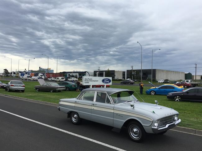 Ford fans gather outside head office. The sign has already changed to "Asia Pacific Product Development Centre". Picture: Joshua Dowling