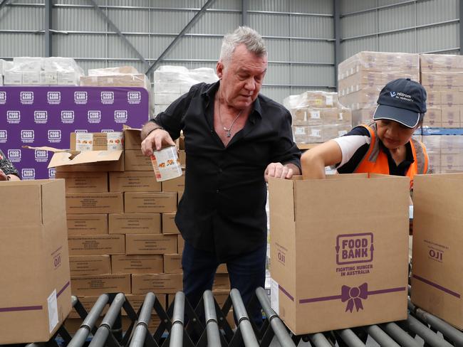 Jimmy Barnes helps pack Christmas hampers. Picture: Jonathan Ng