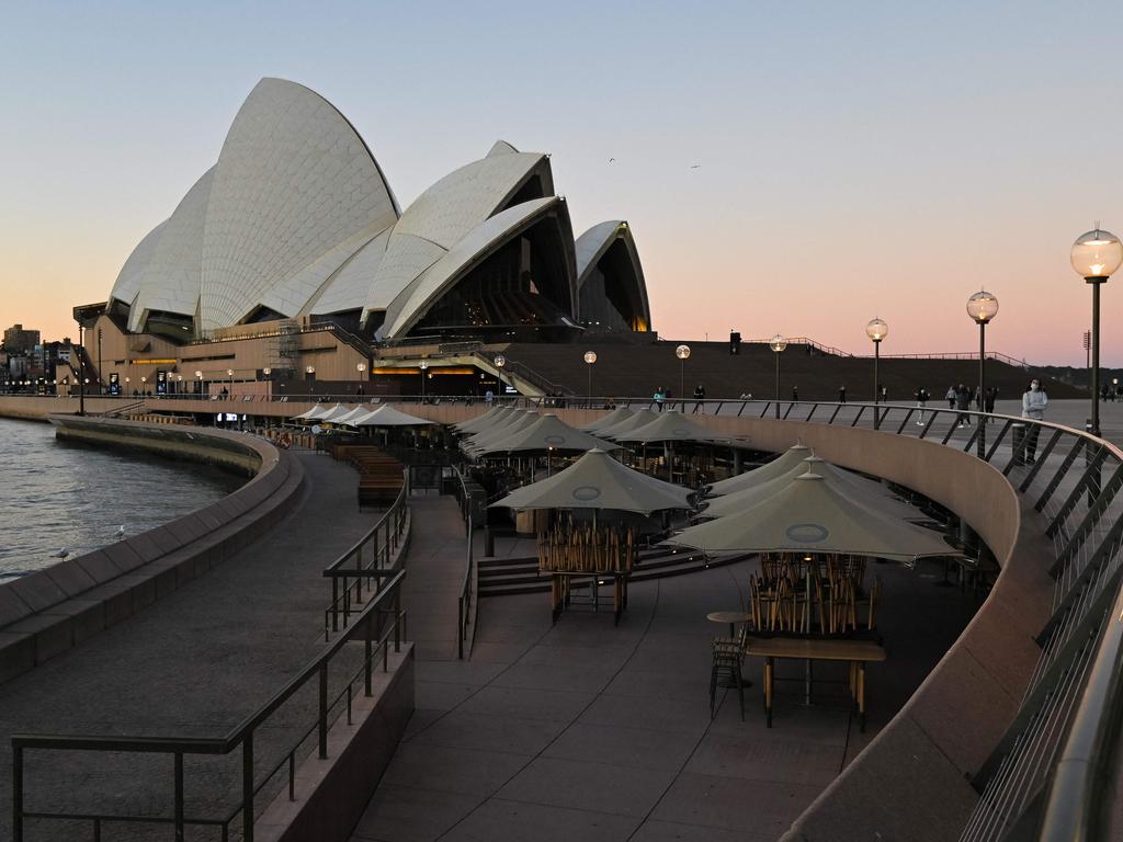 Tables and chairs sit empty along the water in Circular Quay, usually full of visitors at the weekend, in central Sydney. Picture: Steven Saphore