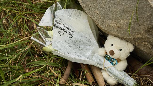 Flowers with a note saying “Rest in peace beautiful boy” along with a small white teddy and a toy car were laid at the scene on Tuesday morning. Picture: Matt Loxton