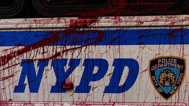 An NYPD transport bus is seen splattered with fake blood as police arrest pro-Palestinian protesters occupying a building (Photo by Alex Kent/Getty Images)