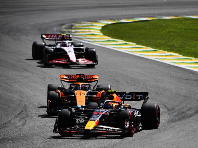 Sergio Perez of Mexico driving the (11) Oracle Red Bull Racing RB19 leads Oscar Piastri of Australia driving the (81) McLaren MCL60 Mercedes on track during the F1 Grand Prix of Brazil. Picture: Getty Images