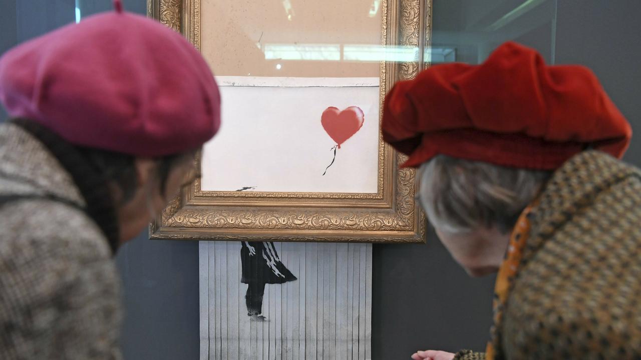 Banksy’s self-shredding painting (originally titled 'Girl with Balloon') has been renamed since destroying itself during an art auction in London. It’s now aptly called 'Love is in the Bin'. Picture: Uli Deck, DPA via AP