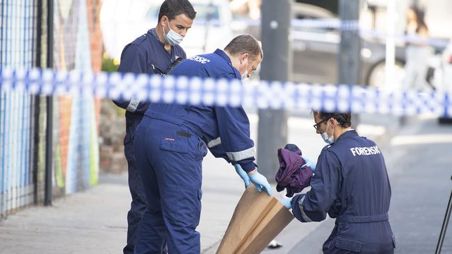 Forensic police examine items at the scene of the Love Machine shooting. Picture: AAP