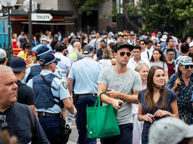 Police helping direct the crowd where space is filling up fast outside circular key around 1.30pm today Monday December 31 2018 ( Image / Monique Harmer)