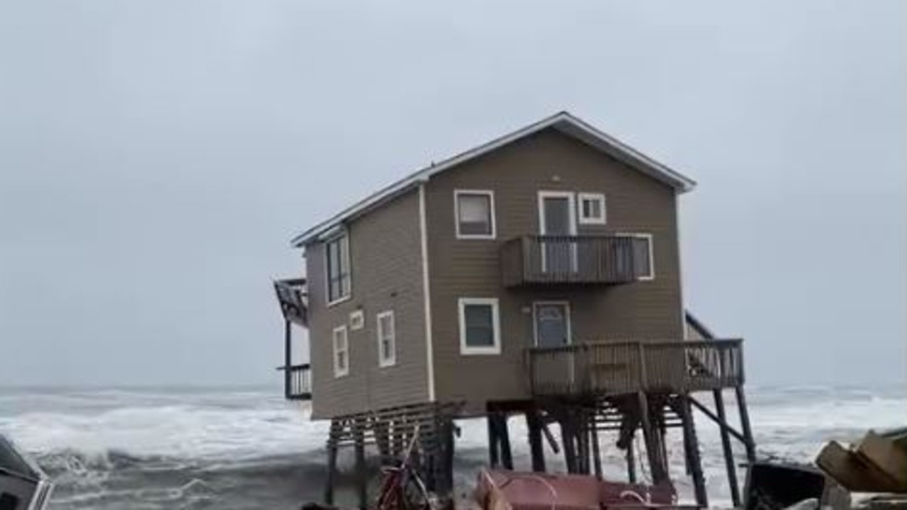 A home topples into the sea in Rodanthe, North Carolina.