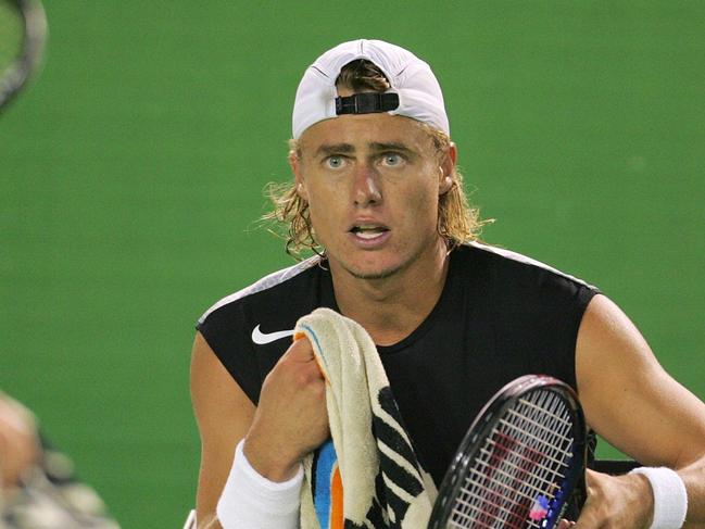 JANUARY 22, 2005: Juan Ignacio Chela (L) just before he appeared to spit as he walks past his opponent Lleyton Hewitt during break in their third round match of 2005 Australian Open at Melbourne Park in Melbourne, 22/01/05.Tennis