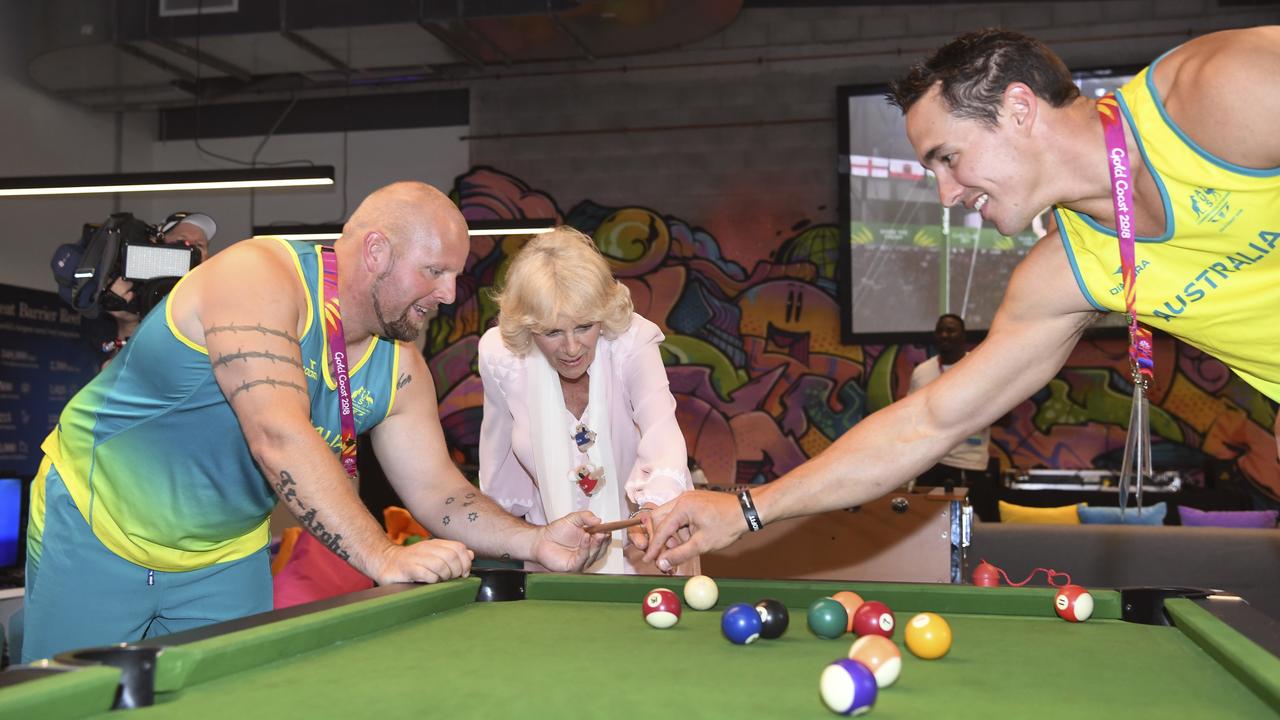 Camilla, Duchess of Cornwall (centre) plays snooker with Australian athletes Marty Jackson (left) and Cameron Crombie during a visit to the Athlete's Village on the Gold Coast, Thursday, April 5, 2018. (AAP Image/AFP Pool/William West)