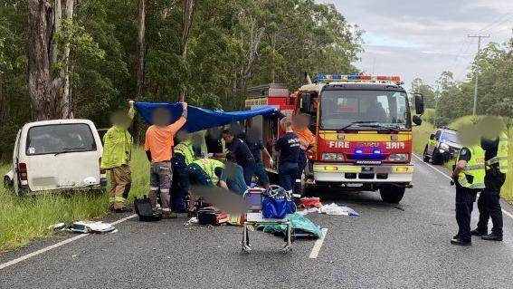 Alex Ritchie and the man who flagged him down helped hold a tarp over the seriously injured van driver during rainy weather while paramedics treated him at the scene. Pics: RACQ Lifeflight