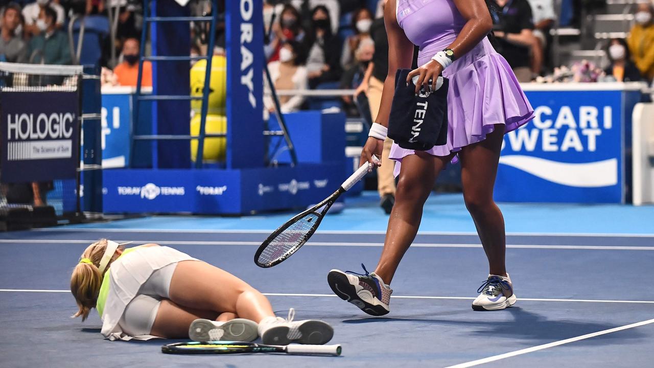 Naomi Osaka of Japan (R) assists Daria Saville of Australia after she injured herself during their women's singles match on day two of the Pan Pacific Open tennis tournament in Tokyo on September 20, 2022. (Photo by Philip FONG / AFP)