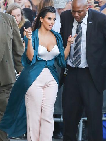 A security guard isn’t taking a single glance away from Kim Kardashian as she makes her way out of Jimmy Kimmel Live in West Hollywood. Picture: Splash