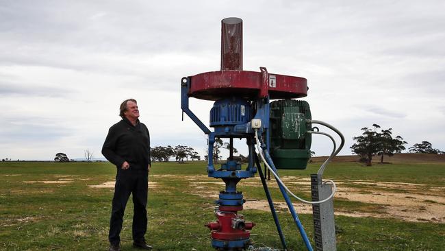 Victorian farmer Gregor McNaughton with an unused CSG well on his property. Picture: Aaron Francis