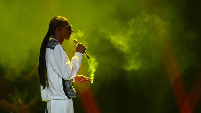 Snoop smokes on stage at a concert in New York City in August. (Photo by ANGELA WEISS / AFP)