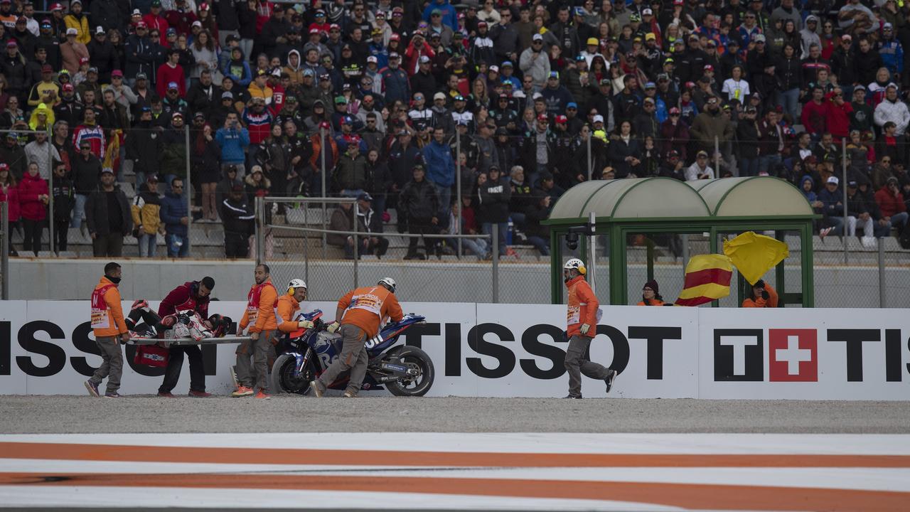 Horrified fans in Valencia watch as Johann Zarco is stretchered away. Picture: Mirco Lazzari