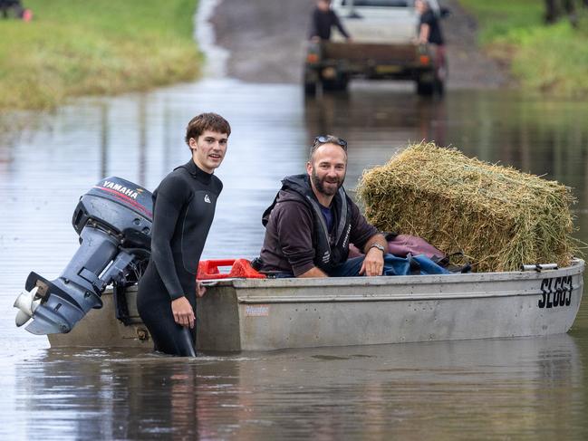 The floods have closed the roads into around Taree neighbours are using boats to cross roads and bring supplies to people trapped by the flood waters.Picture Thomas Lisson