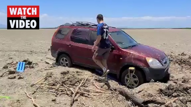 Traveller's car bogged on mudflats