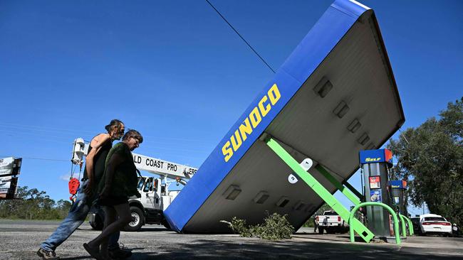 TOPSHOT - A rooftop of a Sunoco gas station destoyed by Hurricane Helene after making landfall is seen in Perry, Florida, on September 27, 2024. Hurricane Helene weakened on September 27 hours after it made landfall in the US state of Florida, with officials warning the storm remained "extremely dangerous" as it surged inland, leaving flooded roads and homes in its wake. (Photo by Chandan Khanna / AFP)