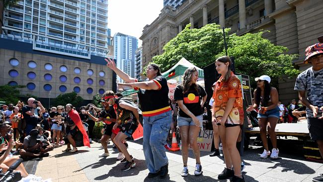 Protesters carried signs that ready “The Queen’s dead, so is the colony’ during an Invasion Day protest in Brisbane’s CBD. Picture: Dan Peled