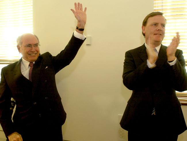 Canberra, October 18, 2004. Prime minister John Howard (left) and Treasurer Peter Costello during the Liberal Party meeting at Parliament House in Canberra today. (AAP Image/Alan Porritt) NO ARCHIVING