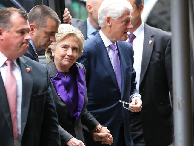 Hillary Clinton, holding hands with her husband, former President Bill Clinton, arrives at a New York hotel to speak to her staff and supporters after losing the race for the White House, Wednesday, Nov. 9, 2016. Earlier in the day she conceded the race to Republican president-elect Donald Trump. (AP Photo/Seth Wenig)