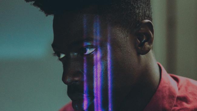 Moses Sumney with a Wolverine meets Prince scratch on his face.