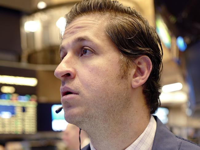 Thomas Donato, center, follows stock prices, Thursday, Feb. 9, 2017, at the New York Stock Exchange. (AP Photo/Mark Lennihan)