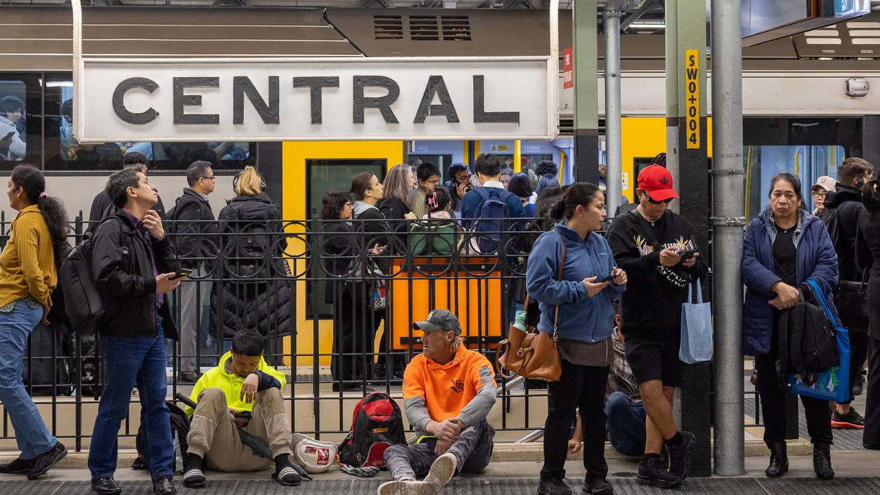People wait on platforms at Central Station after trains on the westbound line came to a halt. Picture: Thomas Lisson