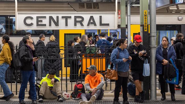 People wait on platforms at Central Station after trains on the westbound line came to a halt. Picture: Thomas Lisson