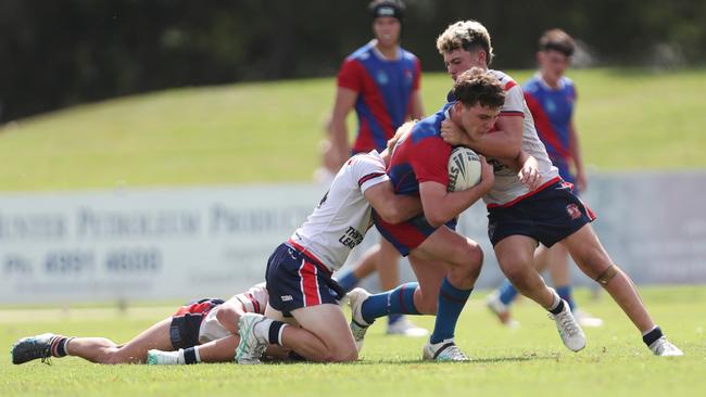 Cody Baker held up by the Roosters’ defence. Picture: Sue Graham