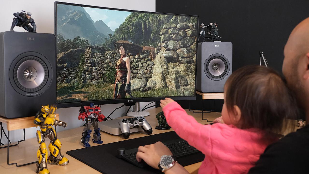 Patrick playing video games with his two-year-old daughter Clarissa.