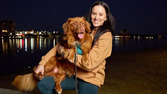 Cassie Schneider with her dog, Juice, 4 at the West Lakes Shore. Picture: Matt Loxton