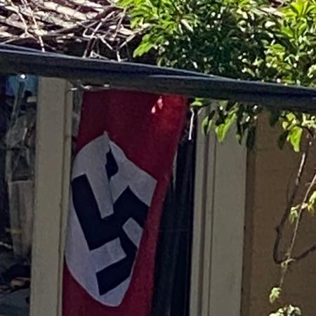 A Nazi swastika flag flies in the backyard of a Newtown home.