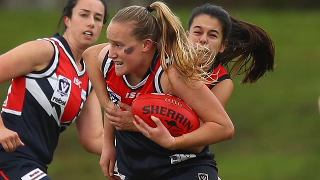 MELBOURNE, AUSTRALIA - JUNE 26: Victoria Blackwood of Darebin is tackled during the round 14 VFLW match between Darebin and Essendon at Bill Lawry Oval on June 26, 2021 in Melbourne, Australia. (Photo by Mike Owen/AFL Photos/via Getty Images)