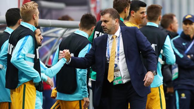 Ange Postecoglou manager of Australia shakes hands with his Australia players.