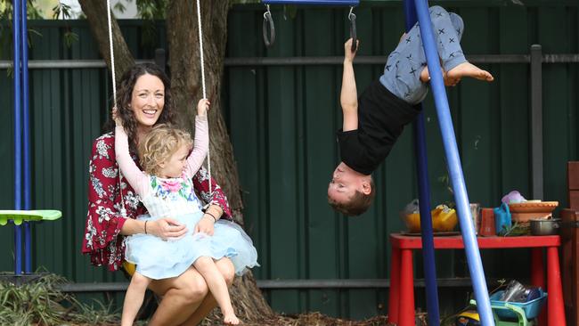 Charlotte Reimer of Magill with her children Chelsea, 3, and Brucey, 6, on the home playground equipment. Picture: Tait Schmaal