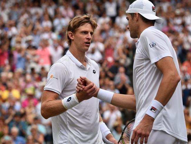 South Africa's Kevin Anderson (L) shakes hands after winning against US player John Isner