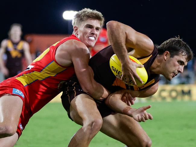 GOLD COAST, AUSTRALIA - APRIL 13: Finn Maginness of the Hawks is tackled by Will Graham of the Suns during the 2024 AFL Round 05 match between the Gold Coast SUNS and the Hawthorn Hawks at People First Stadium on April 13, 2024 in Gold Coast, Australia. (Photo by Russell Freeman/AFL Photos via Getty Images)