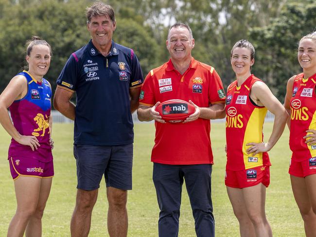 BRISBANE, AUSTRALIA - JANUARY 27: AFLW Brisbane Lions captain Emma Zielke and Lions coach Craig Starcevich pose with Suns Coach David Lake and AFLW Gold Coast Co-captains Sam Virgo and Hannah Dunn at the AFLW season launch on January 27, 2021 in Brisbane, Australia. (Photo by Jono Searle/Getty Images)