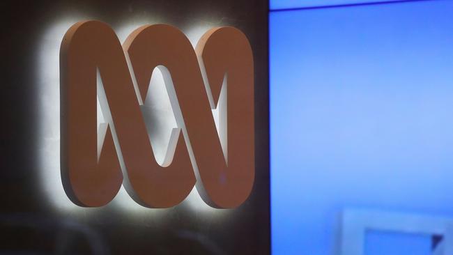 The logo of the ABC can be seen next to a screen displaying news stories at the main entrance to the ABC building located at Ultimo in Sydney, Wednesday, June 5, 2019. Federal police officers have raided ABC's Sydney offices over stories published in 2017 that suggested Australian troops may have committed war crimes. (AAP Image/David Gray) NO ARCHIVING