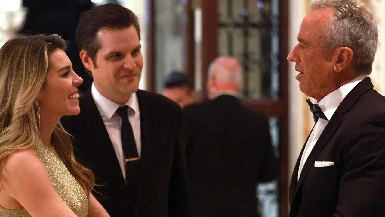 Mr Gaetz (centre) with his wife, Ginger Luckey Gaetz, meeting Mr Trump’s nominee to run America’s federal Health Department, noted anti-vaxxer Robert F. Kennedy Jr, at Mar-a-Lago last week. Picture: Joe Raedle/Getty Images via AFP )